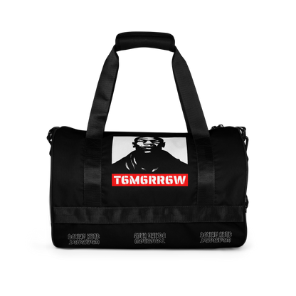 t6m6rr6w Tyson K.O. Code Fighter Gym Bag in black and white colorway. Front view shows iconic Mike Tyson portrait with red t6m6rr6w logo banner. Side views reveal all-over print design featuring multiple Mike Tyson images and repeated t6m6rr6w branding. Duffle-style gym bag with dual padded handles, adjustable shoulder strap, and boxing-themed graphics perfect for fighters and boxing fans.