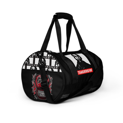 t6m6rr6w Tyson K.O. Code Fighter Gym Bag in black and white colorway. Front view shows iconic Mike Tyson portrait with red t6m6rr6w logo banner. Side views reveal all-over print design featuring multiple Mike Tyson images and repeated t6m6rr6w branding. Duffle-style gym bag with dual padded handles, adjustable shoulder strap, and boxing-themed graphics perfect for fighters and boxing fans.